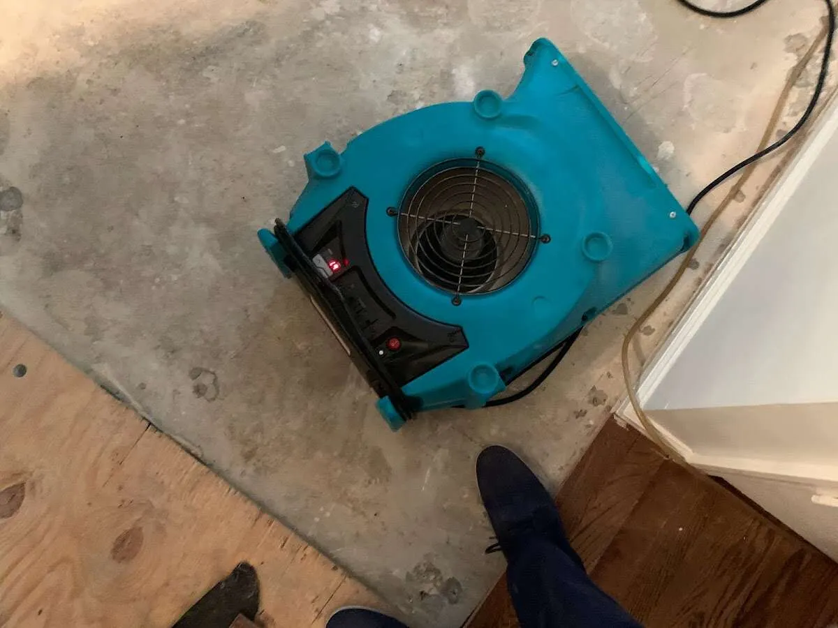 Air mover drying subfloor during Leak Detection & Repair in St. Paul Park